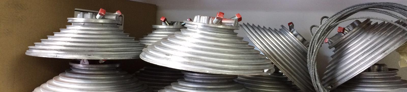 - Garage door hardware components, including cable drums and cables, prepared for expert repair services.